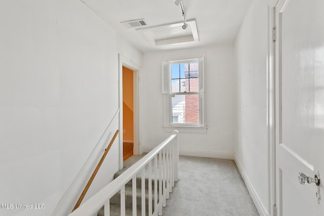 hall featuring light colored carpet