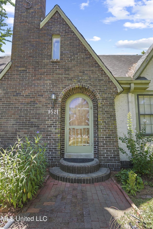 1521 Riverside Dr, Jackson, MS 39202 - view of exterior entry featuring a chimney and brick siding