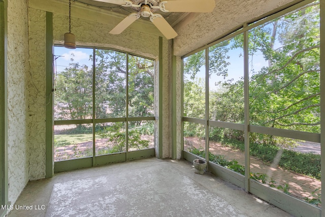 unfurnished sunroom featuring ceiling fan