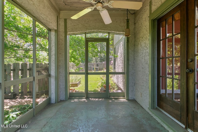 unfurnished sunroom featuring ceiling fan