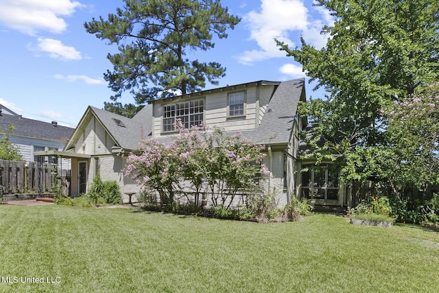 1521 Riverside Dr, Jackson, MS 39202 - view of front facade featuring fence, a shingled roof, and a front lawn