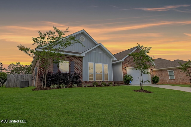 19489 Little Manatee St, Biloxi, MS 39532 - view of front of property featuring brick siding, a garage, concrete driveway, board and batten siding, and central AC unit