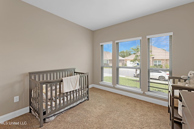 19489 Little Manatee St, Biloxi, MS 39532 - carpeted bedroom with baseboards and a crib