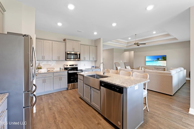 19489 Little Manatee St, Biloxi, MS 39532 - kitchen with stainless steel appliances, a sink, gray cabinets, open floor plan, and a ceiling fan