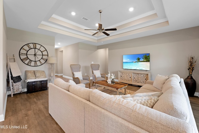 19489 Little Manatee St, Biloxi, MS 39532 - living room with wood finished floors, ceiling fan, a raised ceiling, baseboards, and ornamental molding