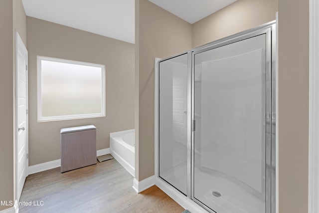 19489 Little Manatee St, Biloxi, MS 39532 - full bath with wood finished floors, a garden tub, a stall shower, and baseboards