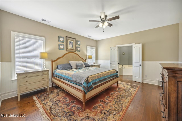 bedroom with dark hardwood / wood-style floors and ceiling fan