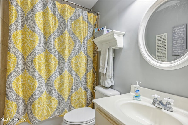 bathroom featuring toilet, a shower with curtain, and vanity