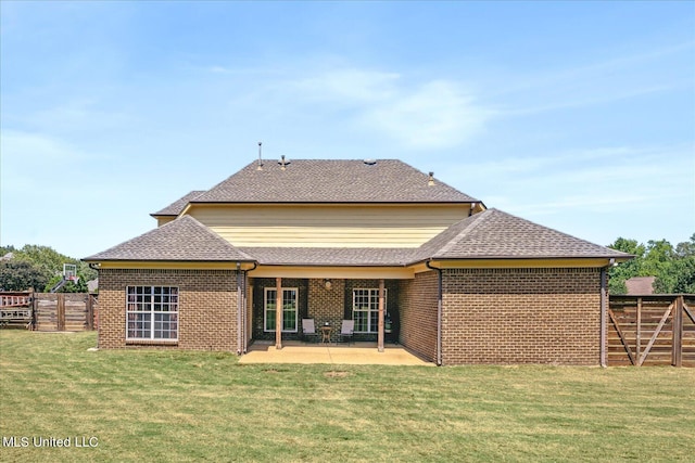 rear view of house featuring a yard and a patio