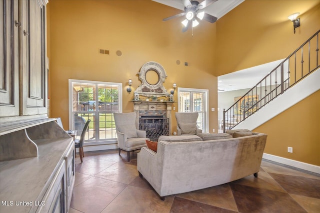 living room with a towering ceiling and ceiling fan