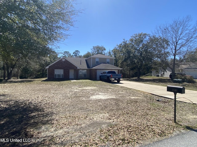 view of front of property featuring a garage and concrete driveway