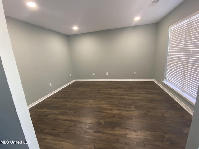 unfurnished room featuring dark wood-style floors, recessed lighting, and baseboards