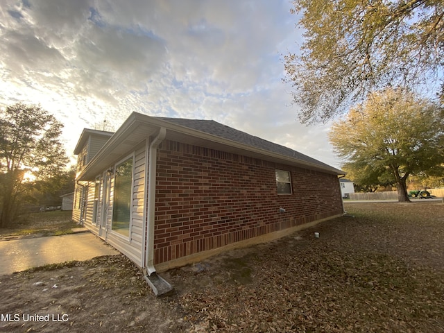 view of side of home with brick siding