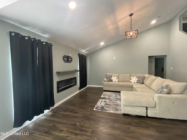 living area featuring a glass covered fireplace, lofted ceiling, dark wood-style floors, a notable chandelier, and recessed lighting