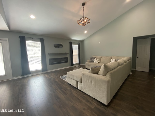 living room with a glass covered fireplace, dark wood-style flooring, baseboards, and recessed lighting