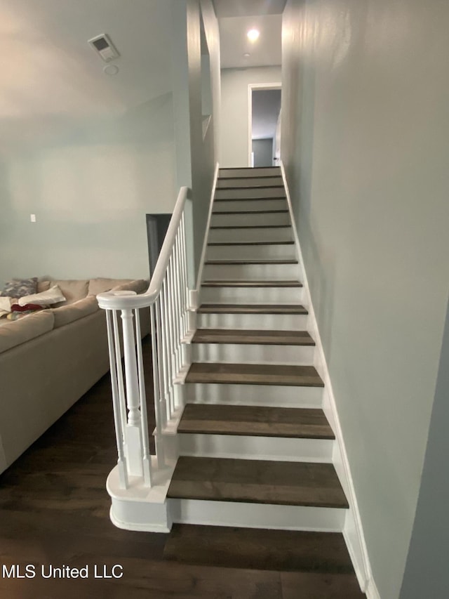 stairs featuring baseboards and wood finished floors