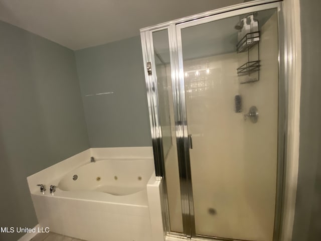 full bath featuring a stall shower and a tub with jets