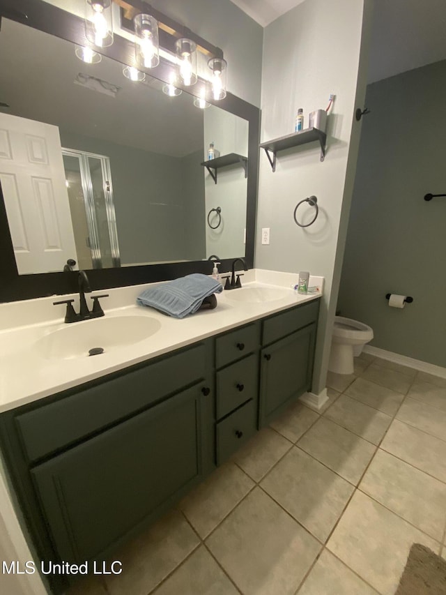 bathroom with double vanity, tile patterned flooring, a shower stall, and a sink