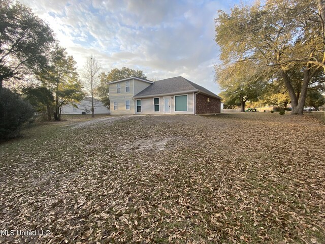 back of property featuring brick siding