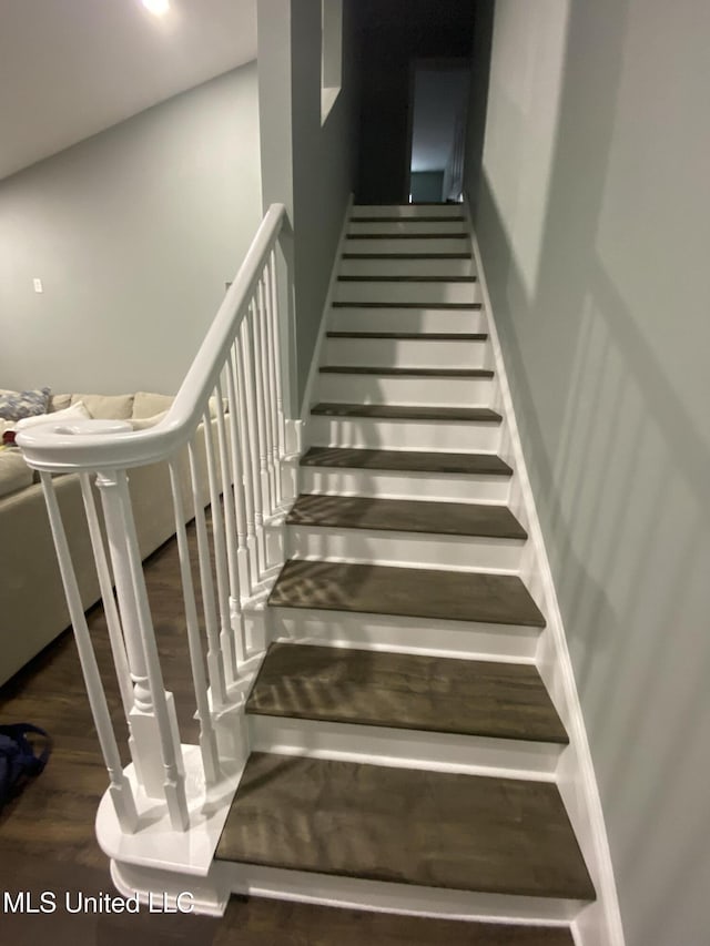 stairs featuring wood finished floors