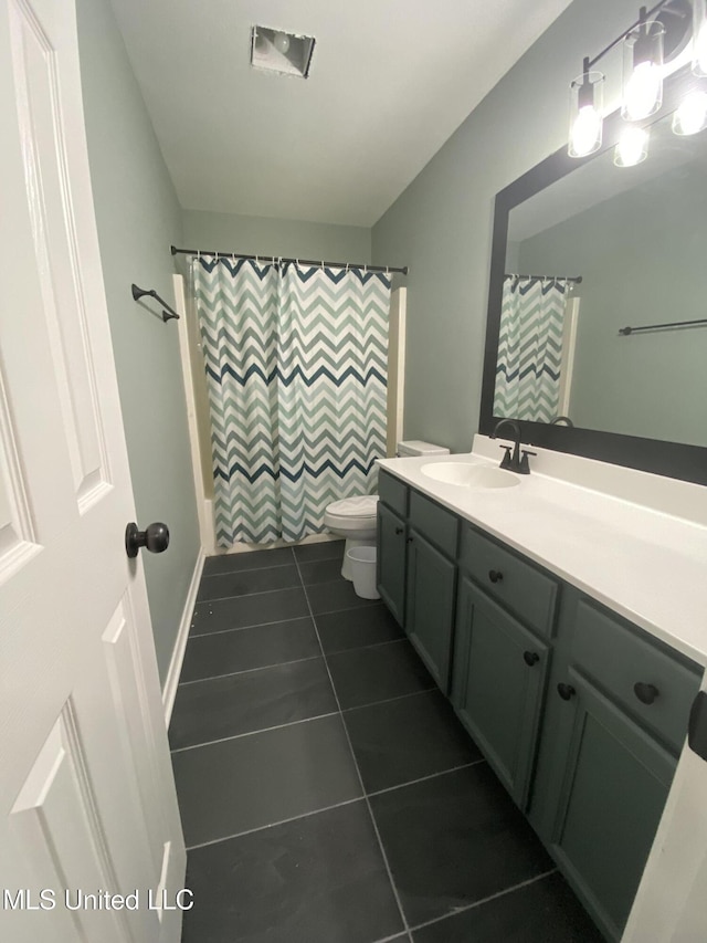 full bath featuring a shower with shower curtain, vanity, toilet, and tile patterned floors