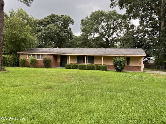 single story home with a front yard and brick siding