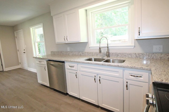 136 Childress Rd, Lucedale, MS 39452 - kitchen with stainless steel appliances, a sink, white cabinets, light wood-style flooring, and light stone counters