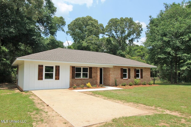 136 Childress Rd, Lucedale, MS 39452 - single story home with a front lawn, board and batten siding, driveway, roof with shingles, and brick siding