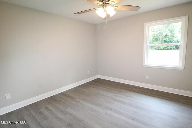136 Childress Rd, Lucedale, MS 39452 - empty room with a ceiling fan, dark wood finished floors, and baseboards