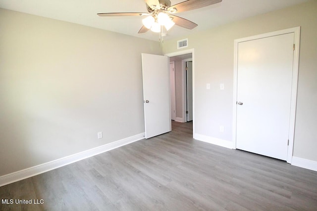 136 Childress Rd, Lucedale, MS 39452 - unfurnished bedroom featuring wood finished floors, baseboards, and a ceiling fan