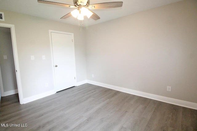 136 Childress Rd, Lucedale, MS 39452 - unfurnished bedroom featuring dark wood-style floors, baseboards, and ceiling fan