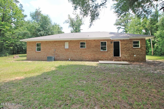 136 Childress Rd, Lucedale, MS 39452 - rear view of property featuring a patio, brick siding, a lawn, entry steps, and central AC unit