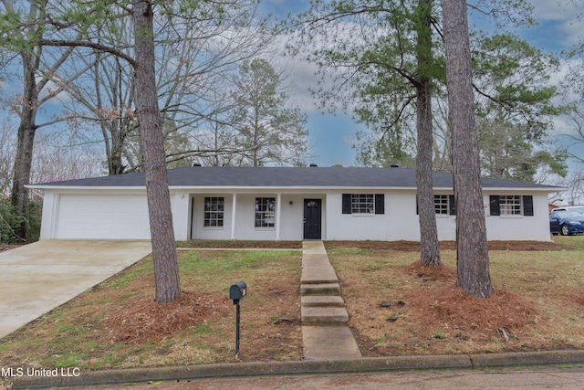 ranch-style house featuring a garage, a front yard, brick siding, and driveway