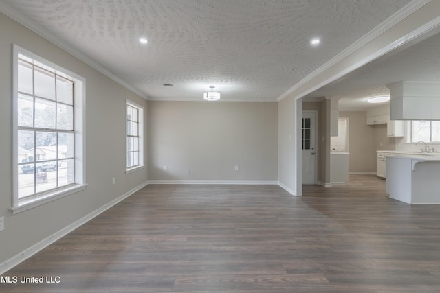 unfurnished living room with crown molding, baseboards, and dark wood-type flooring