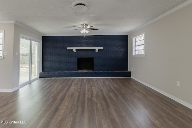 unfurnished living room featuring a wealth of natural light, wood finished floors, a fireplace, and crown molding