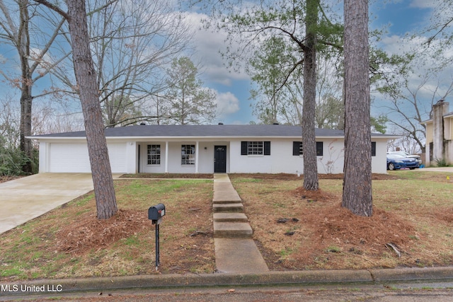 ranch-style house with a front lawn, concrete driveway, and an attached garage