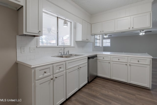 kitchen with a peninsula, ceiling fan, a sink, light countertops, and dishwasher