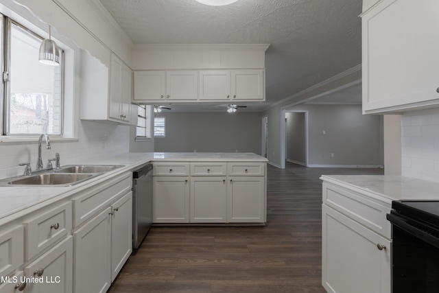 kitchen featuring a sink, dark wood finished floors, light countertops, a peninsula, and stainless steel dishwasher