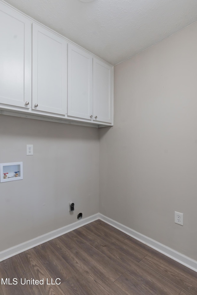 washroom featuring baseboards, cabinet space, washer hookup, and dark wood-style flooring