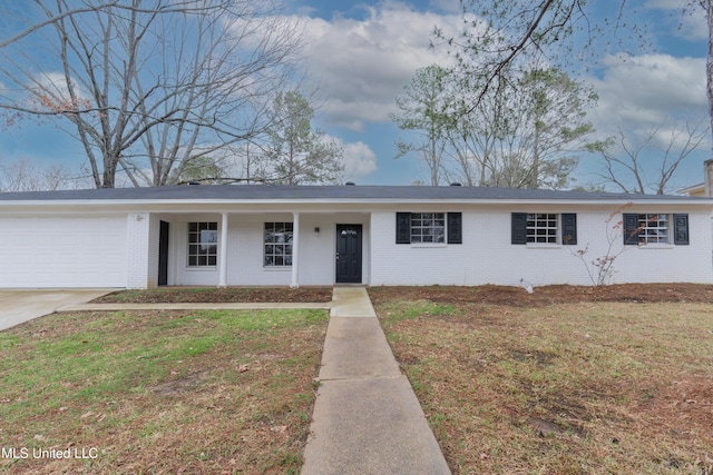 single story home with a front yard, brick siding, a garage, and driveway