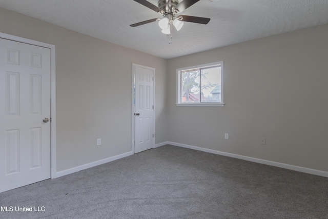 unfurnished bedroom featuring baseboards, carpet floors, and a textured ceiling