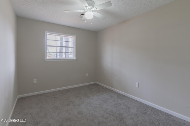 carpeted empty room with baseboards, a textured ceiling, and a ceiling fan