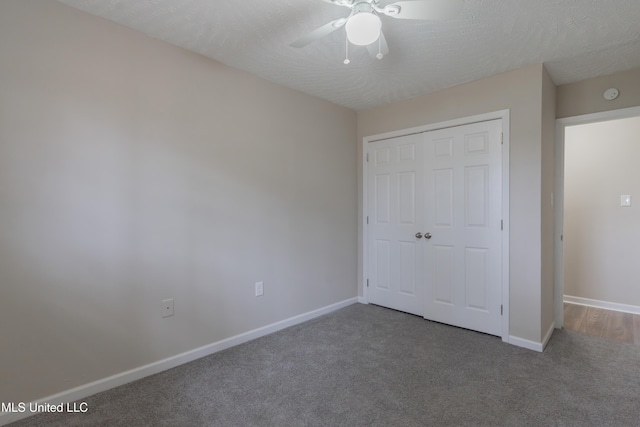 unfurnished bedroom with a closet, baseboards, carpet floors, and a textured ceiling