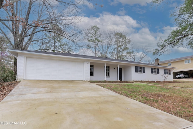 view of front of home with brick siding, concrete driveway, and a garage