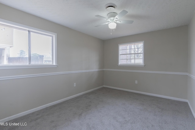 unfurnished room featuring a ceiling fan, baseboards, and carpet floors