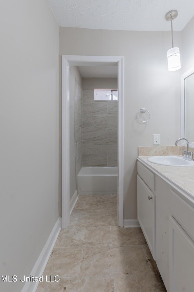 bathroom featuring baseboards, a textured ceiling,  shower combination, and vanity