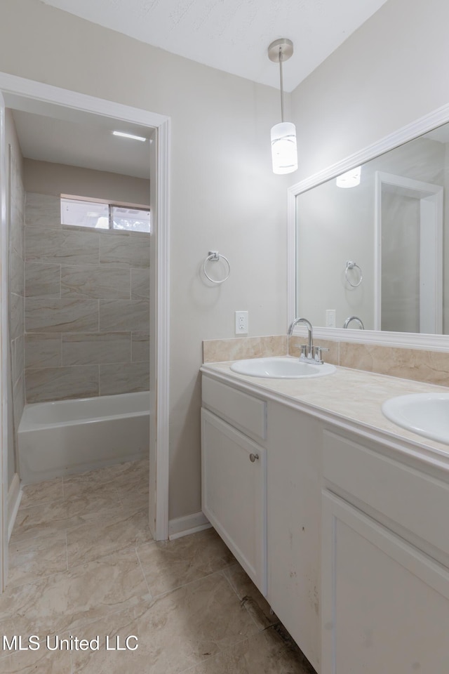 bathroom featuring a sink, shower / bathtub combination, and double vanity