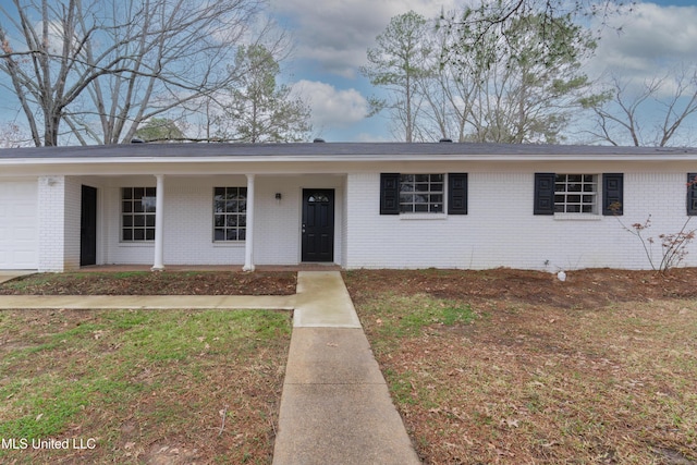 single story home featuring brick siding and a garage