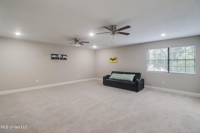 living area featuring ceiling fan and light colored carpet