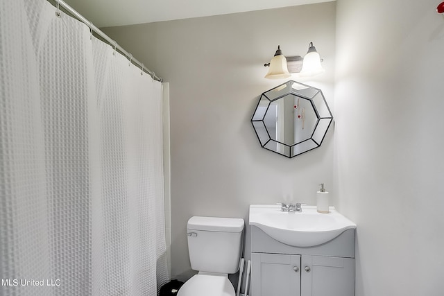 bathroom featuring vanity, toilet, and walk in shower